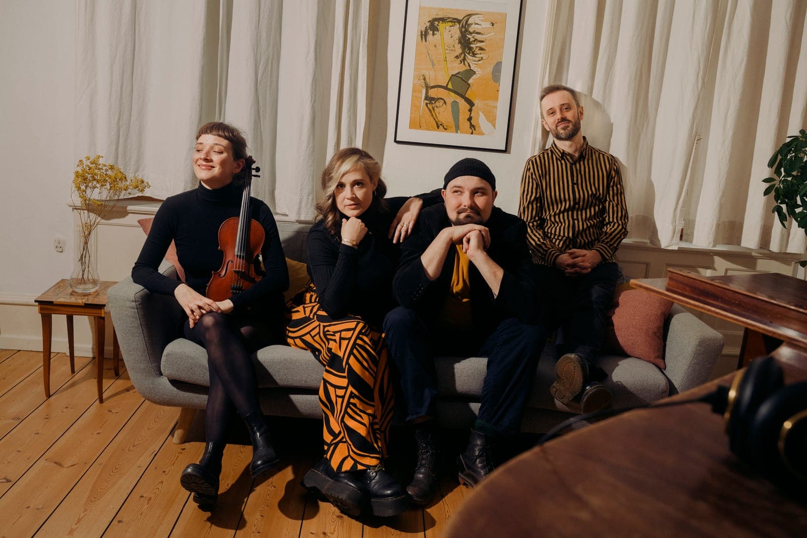 Floating Sofa Quartets fire musikere samlet på en sofa med en violin